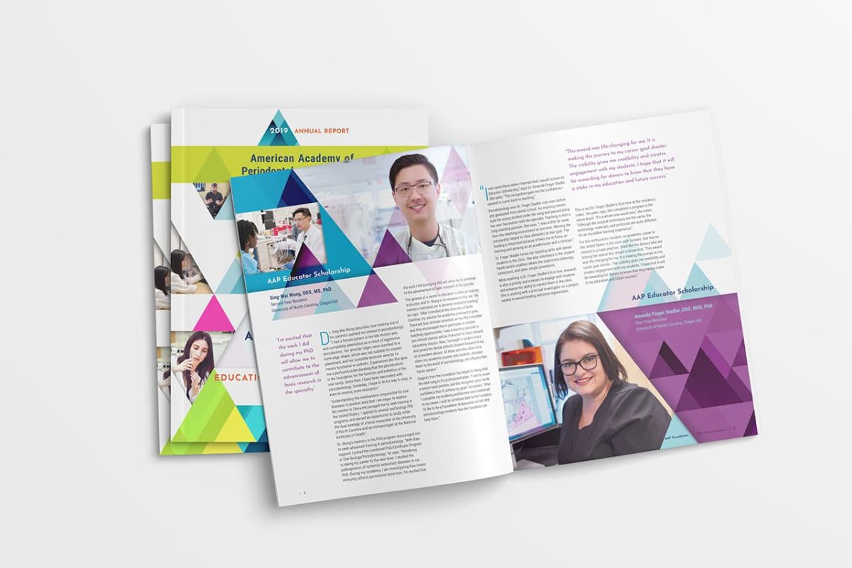 multiple copies of the annual report with one opened to a page with informative copy