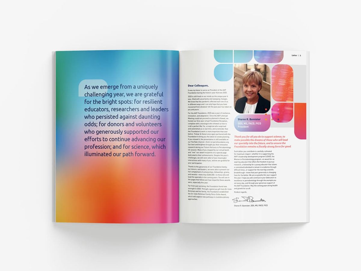 an open copy of the annual report with a colorful design on the left page