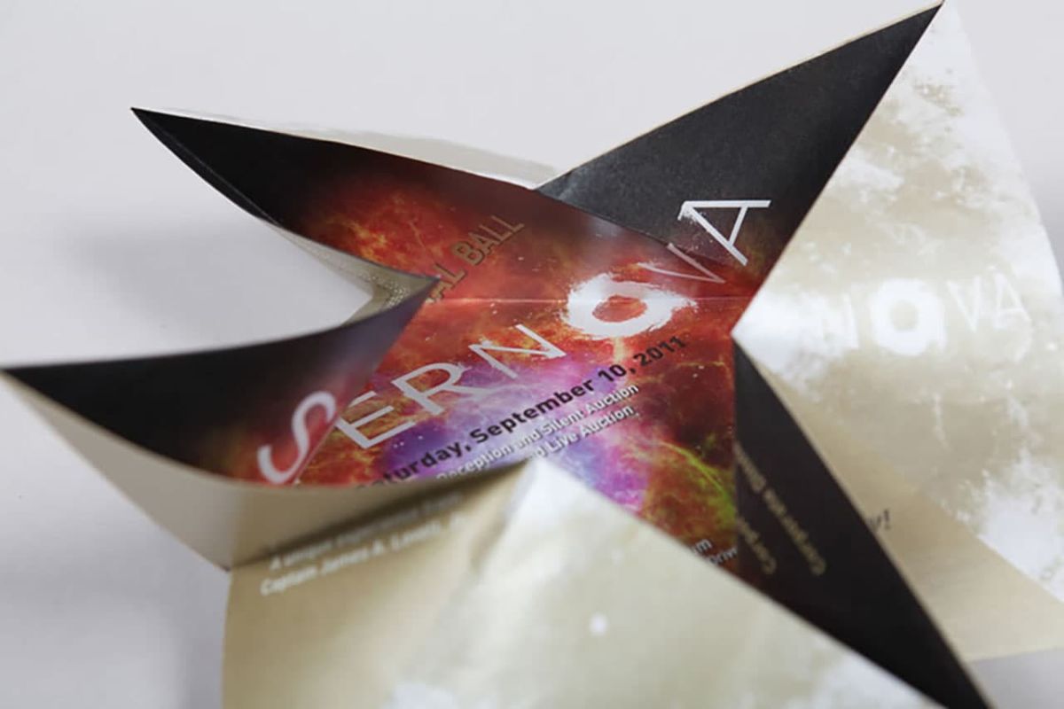 Adler Planetarium 2011 Celestial Ball Invitation in the middle of being folded